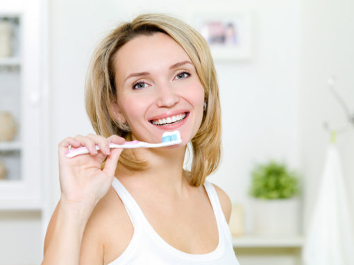 young-woman-holds-toothbrush-with-toothpaste